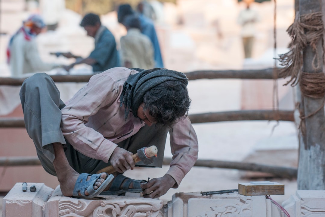 Craftsman carving a granite monument by hand